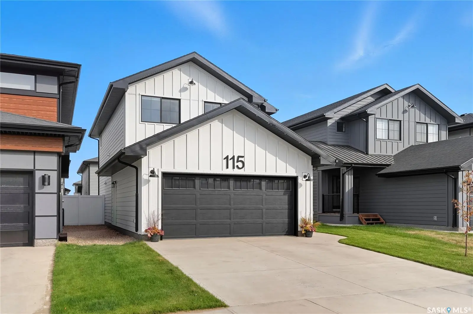 Exterior photo of 115 Leskiw Lane, Saskatoon, SK showing front view of newly built two-storey home with attached garage